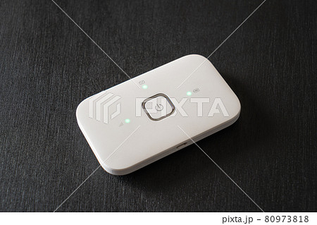 White pocket Wi-Fi hotspot device on black background. White pocket Wi-Fi hotspot device on black background. 80973818