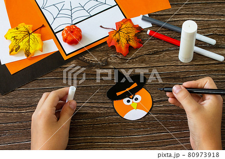 Instructions, step 7. Greeting card for Halloween on a wooden table. Childrens art project, handmade, crafts for children. Instructions, step 7. Greeting card for Halloween on a wooden table. Childrens art project, handmade, crafts for children. 80973918