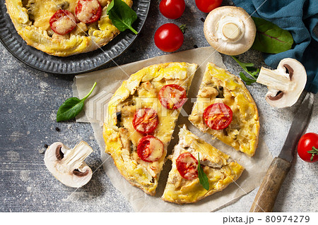 Homemade pastries with whole grain flour. Galette with chicken, cheese and mushrooms on a stone or slate countertop. Top view flat lay background. Homemade pastries with whole grain flour. Galette with chicken, cheese and mushrooms on a stone or slate countertop. Top view flat lay background. 80974279