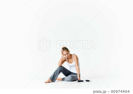 woman sitting on the floor with dumbbells exercise health motivation woman sitting on the floor with dumbbells exercise health motivation 80974404