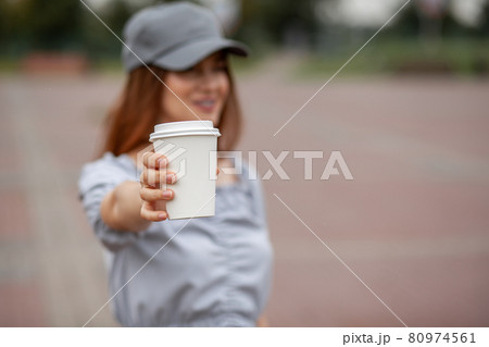 White paper cup with coffee in woman hand. Time for drink coffee in city. Coffee to go. Enjoy moment, take a break. Disposable paper cup closeup. Delicious hot beverage. Blank space for text, mockup White paper cup with coffee in woman hand. Time for drink coffee in city. Coffee to go. Enjoy moment, take a break. Disposable paper cup closeup. Delicious hot beverage. Blank space for text, mockup 80974561