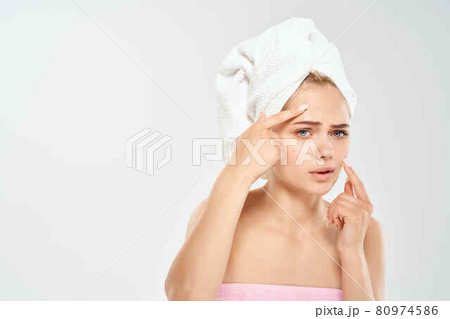 woman with towel on head health clean skin point on face 80974586