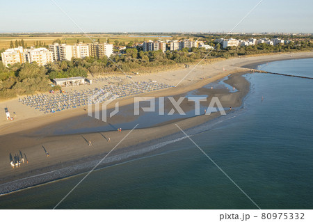 Nice Drone view of sandy beach with umbrellas and gazebos 80975332