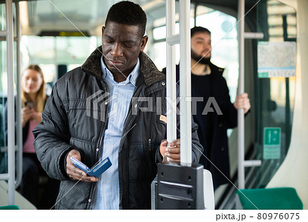 African man with phone in city tram African man with phone in city tram 80976075