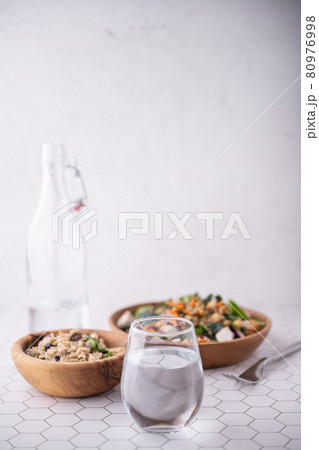 glass of mineral water and healthy salad 80976998