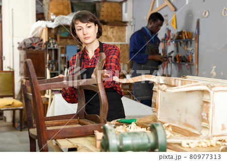 Kestorer inspecting antique armchair 80977313
