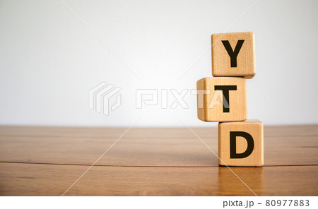 YTD symbol. Word 'YTD - year-to-date' on cubes on a beautiful wooden table, white background. Business and YTD concept. YTD symbol. Word 'YTD - year-to-date' on cubes on a beautiful wooden table, white background. Business and YTD concept. 80977883