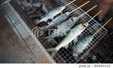 網の上で焼かれる、とれたての鮎とアマゴ 網の上で焼かれる、とれたての鮎とアマゴ 80984418