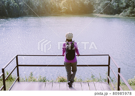 Backpacking women standing and looking beautiful view at nature,Back view Backpacking women standing and looking beautiful view at nature,Back view 80985978