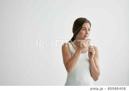 woman wiping her face with a handkerchief fire health problems flu woman wiping her face with a handkerchief fire health problems flu 80986408