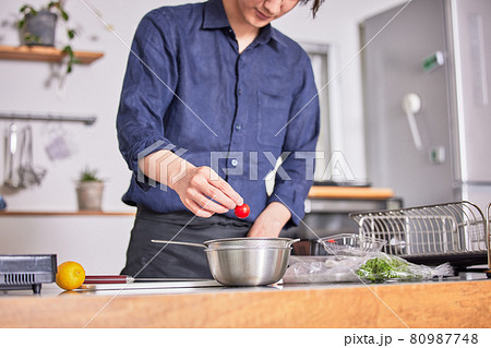 キッチンで料理をするエプロン姿の若い男性　料理男子イメージ 80987748