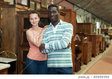 Happy international couple in furnishing store 80989360