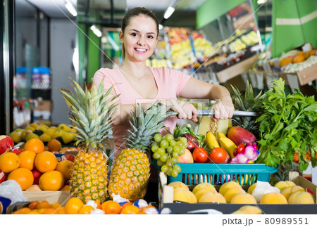 woman with basket with fresh greengrocery enjoying purchases in vegetable store woman with basket with fresh greengrocery enjoying purchases in vegetable store 80989551
