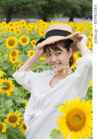 ひまわり畑のなかで女性ポートレート 80992563