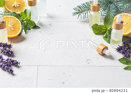 Different types of essential oils in glass bottles and ingredients for making essential oils. Skin and body care concept. Different types of essential oils in glass bottles and ingredients for making essential oils. Skin and body care concept. 80994231