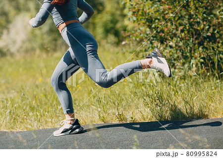 Runner woman in running shoes closeup of woman sporty legs. Female jogging. 80995824