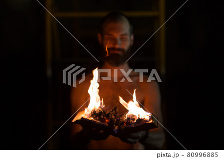 Man hold burning book in his hands. 80996885