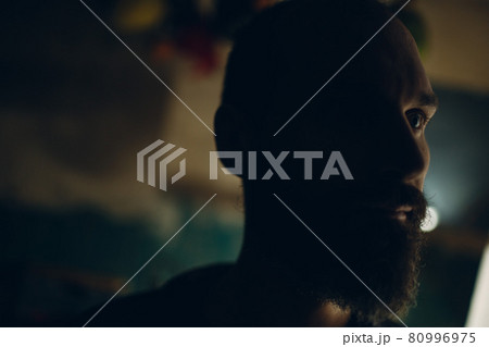 Backlit bearded adult man portrait in dark 80996975