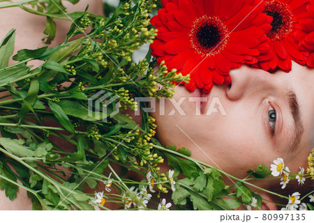 Young man model with flowers. Beauty boy portrait. 80997135