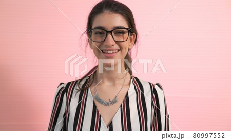 Portrait of young woman merrily pose in studio 80997552