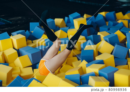 Young and beautiful woman plays in dry pool with cubes Young and beautiful woman plays in dry pool with cubes 80998936