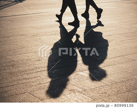 People walking on Pathway Silhouette Shadow sunlight shade Conceptual background 80999136