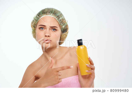 woman with pink towel nude ringlets cream skin care light background woman with pink towel nude ringlets cream skin care light background 80999480