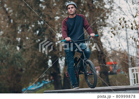 Professional young sportsman cyclist with bmx bike at skatepark. 80999878