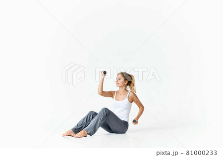 woman with green dumbbells in hands exercise workout gym fitness 81000233