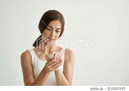 woman holding hand health problems injury close-up 81000345