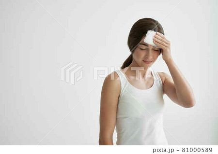 woman picks sweat from face with white handkerchief health problems 81000589