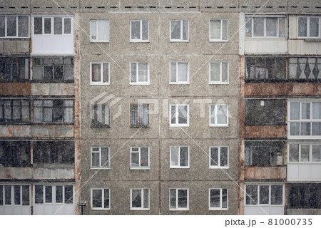 Facade of a grey multi-storey soviet panel building Facade of a grey multi-storey soviet panel building 81000735
