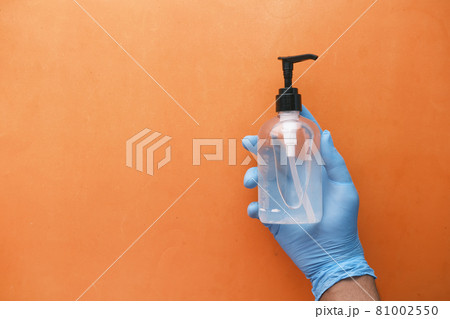doctor hand in latex gloves holding hand sanitizer doctor hand in latex gloves holding hand sanitizer 81002550