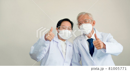 Two Asian senior doctors scientist show successful victory gestu 81005771