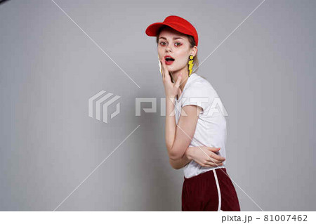 emotional girl in a red cap bright makeup yellow earrings jewelry accessories 81007462