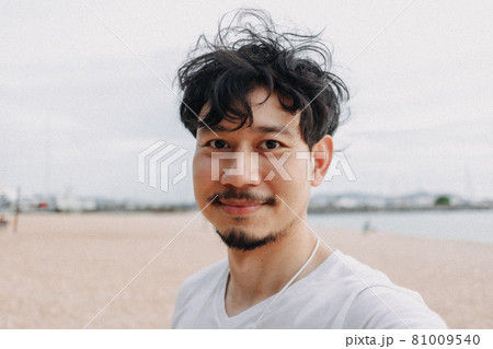 Happy man selfie himself relaxed on the beach. Concept of summer holiday. Happy man selfie himself relaxed on the beach. Concept of summer holiday. 81009540