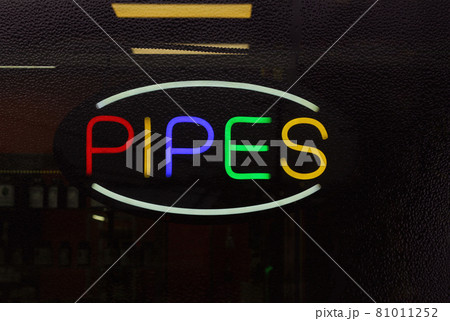 Colorful Neon Pipes Sign in Rainy Window of Smoke Shop Colorful Neon Pipes Sign in Rainy Window of Smoke Shop 81011252