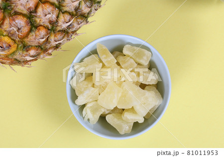 Fresh and Dried Pineapple on yellow Background Closeup 81011953