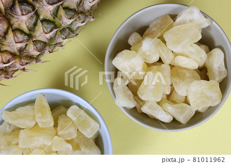 Fresh and Dried Pineapple on yellow Background Closeup Fresh and Dried Pineapple on yellow Background Closeup 81011962