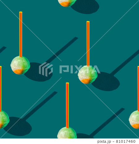 Photo in the form of a seamless pattern. Candy on a stick with shadows on a colored blue-green 81017460