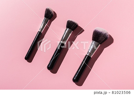 Various make-up brushes on pink background, top view. Cosmetics and beauty concept. 81023506