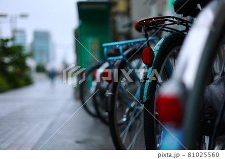 雨の駐輪場に停められた自転車 81025560