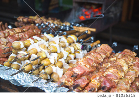 Raw meat and potatoes prepared for frying on skewers. Raw meat and potatoes prepared for frying on skewers. 81026318