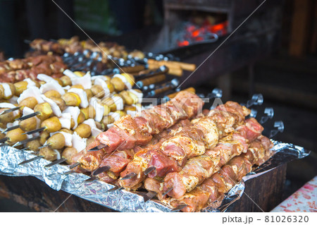 Raw meat and potatoes prepared for frying on skewers. Raw meat and potatoes prepared for frying on skewers. 81026320