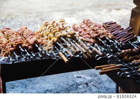 Meat and potatoes prepared for frying on skewers. 81026324