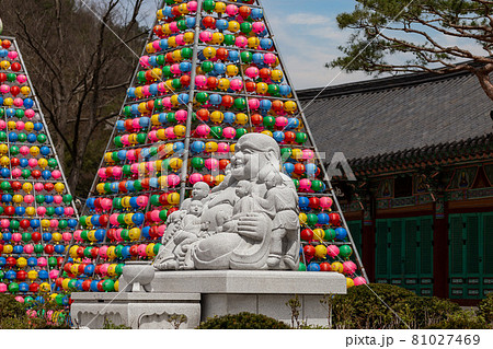 Buddha statue in a buddhist temple Songgwangsa, colorful lantern towers on background, South Korea 81027469