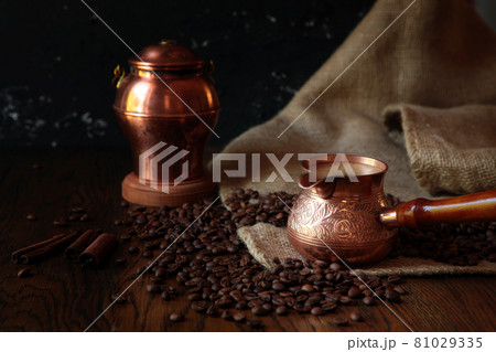 Cezve-traditional cup of coffee, bag and scoop on old rusty background. Dark food photography. 81029335