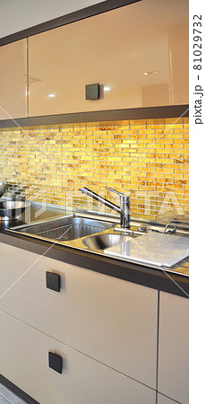 Interior of modern kitchen equipment, brown and beige cabinets Interior of modern kitchen equipment, brown and beige cabinets 81029732
