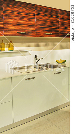 Interior of modern kitchen equipment, white and ebony cabinets Interior of modern kitchen equipment, white and ebony cabinets 81029753