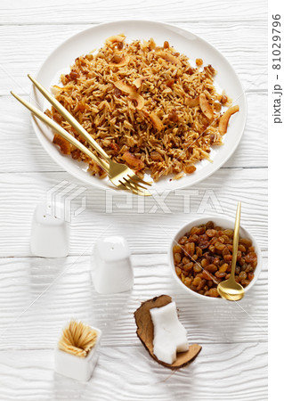 Coconut Rice with raisins on a plate, top view Coconut Rice with raisins on a plate, top view 81029796